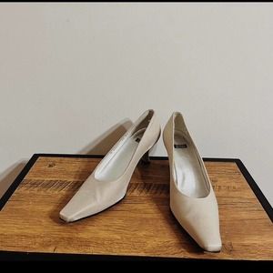 Ivory satin Stuart Weitzman pointed-toe pumps
